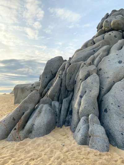 Brown gray rock on the beach during the day
